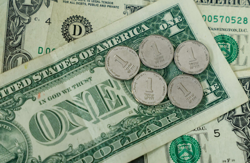 US and Israeli currency (1 dollar bills and 1 shekel coins respectively) are seen in this illustrative photo of money.