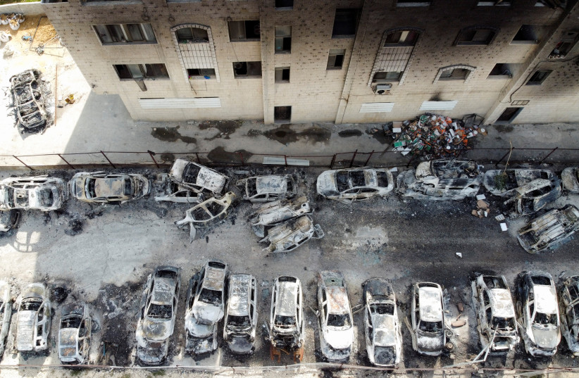  An aerial view shows a building and cars burnt in an attack by Israeli settlers, following an incident where a Palestinian gunman killed two Israeli settlers, near Hawara in the Israeli-occupied West Bank, February 27, 2023 (credit: REUTERS/AMMAR AWAD)