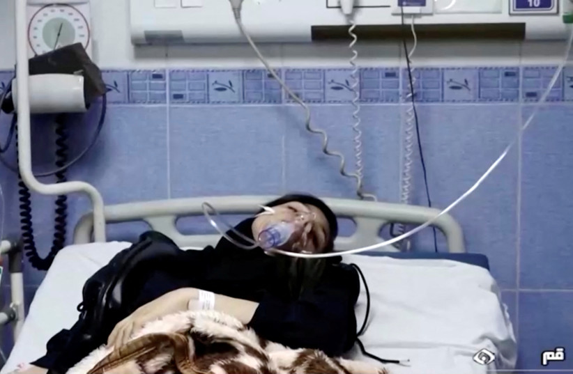  A young woman lies in hospital after reports of poisoning at an unspecified location in Iran in this still image from video from March 2, 2023. (credit: WANA/REUTERS)