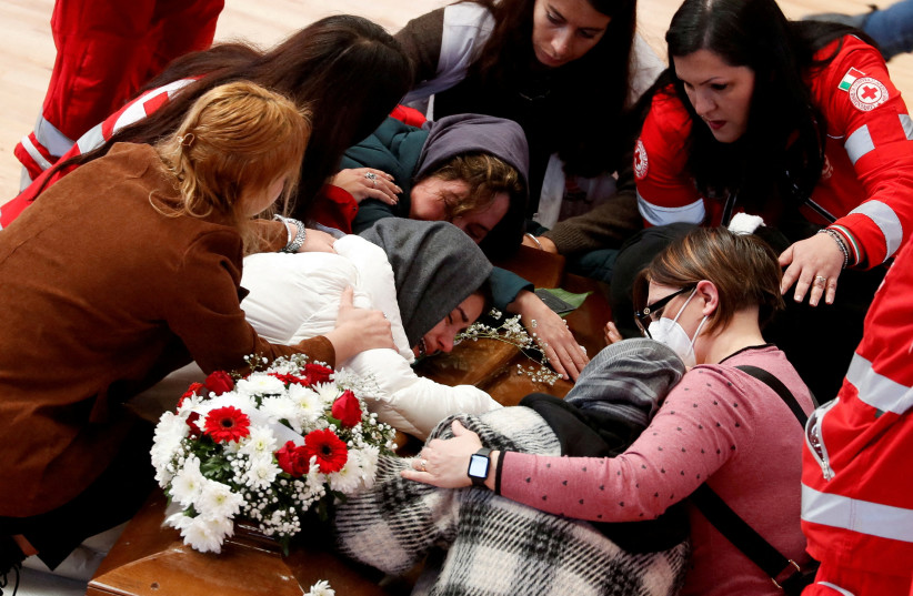  Mourners react near a coffin of a victim who died in a migrant shipwreck, in Crotone, Italy March 1, 2023. (photo credit: REMO CASSILI/REUTERS)