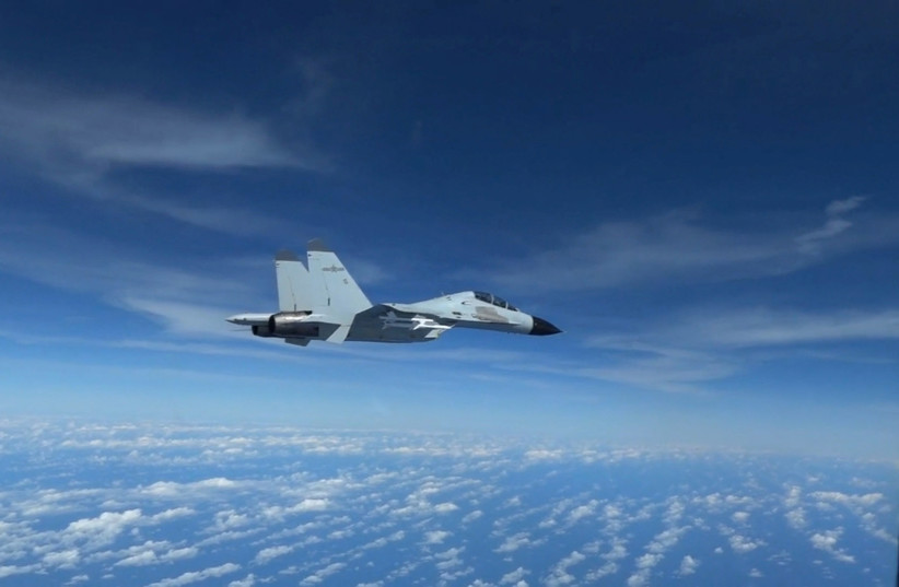  A Chinese Navy J-11 fighter jet is recorded flying close to a US Air Force RC-135 aircraft in international airspace over the South China Sea, according to the US military, in a still image from video taken December 21, 2022. (photo credit: US Indo-Pacific Command/Handout via REUTERS)