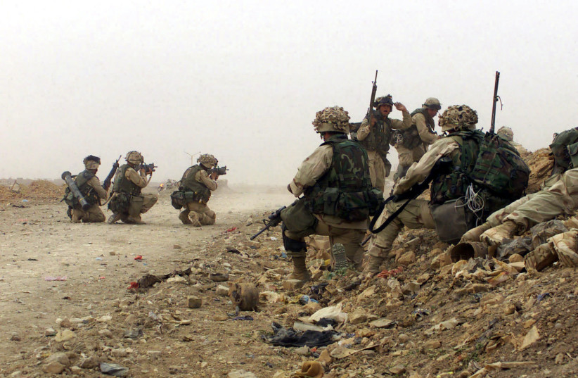  US Marine Corps (USMC) Marines assigned to C/Company, 1ST Battalion, 5th Marines, 1ST Marine Division engage the enemy during a firefight with Iraqi Forces near Baghdad, Iraq, during Operation IRAQI FREEDOM (photo credit: NARA)