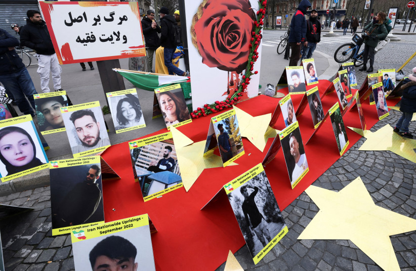 Pictures of people who died during demonstrations in Iran are displayed as Iranian community members and supporters of the National Council of Iran take part in a protest in solidarity with Iranian people, in Paris, France, February 12, 2023.  (photo credit: YVES HERMAN/REUTERS)
