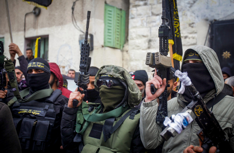  Palestinian gunmen and mourners attend the funeral of one of the two Palestinians who were killed by Israeli security forces after they opened fire on military post, in Jaba, near Jenin, in the West Bank, January 14, 2023 (photo credit: NASSER ISHTAYEH/FLASH90)