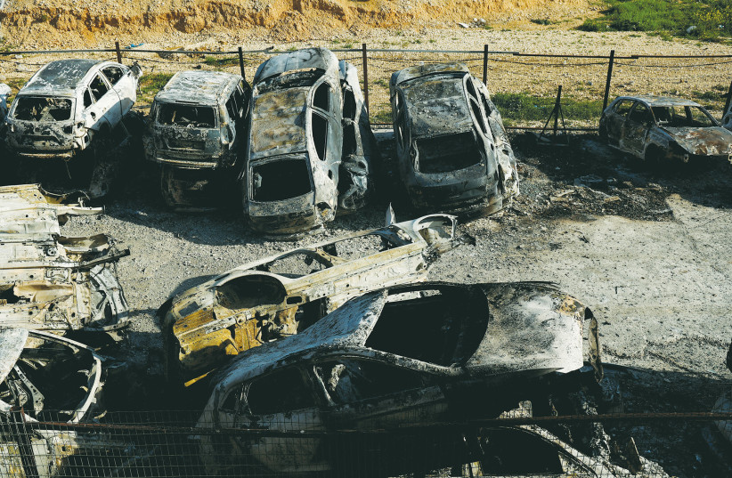  CARS ARE gutted following a rampage by settlers in the Palestinian village of Huwara, after terrorists killed two Israeli brothers, last month.  (photo credit: AMMAR AWAD/REUTERS)