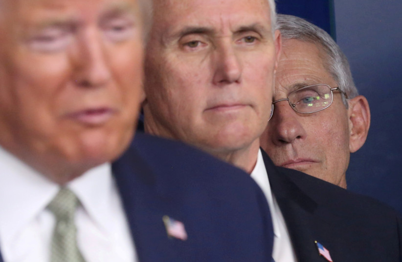  National Institute of Allergy and Infectious Diseases Director Anthony Fauci listens with Vice President Mike Pence as U.S. President Donald Trump addresses the daily coronavirus briefing at the White House in Washington, US, March 17, 2020 (credit: REUTERS/JONATHAN ERNST)