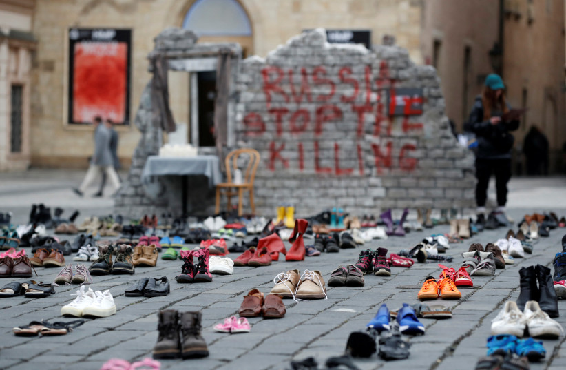  Shoes symbolizing war crimes committed against Ukrainian civilians are placed at the Old Town Square to mark the one-year anniversary of the Russian invasion of Ukraine, in Prague, Czech Republic February 15, 2023 (credit: REUTERS/DAVID W CERNY)
