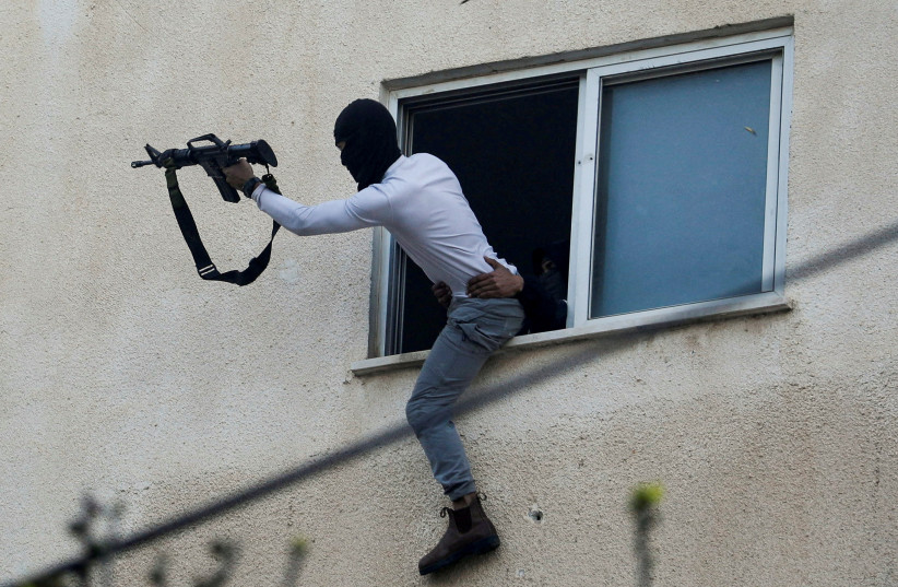 Palestinians clash with Israeli troops during an Israeli army raid in Jenin in the West Bank, March 7,2023. (photo credit: REUTERS/RANEEN SAWAFTA)