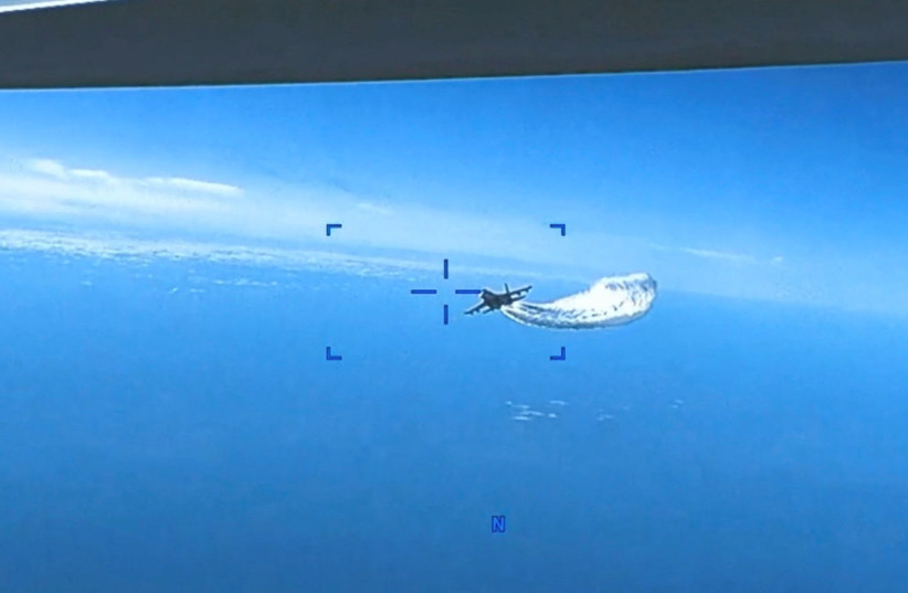  A Russian Su-27 aircraft dumps fuel while flying upon a U.S. Air Force intelligence, surveillance, and reconnaissance unmanned MQ-9 aircraft over the Black Sea, March 14, 2023 in this still image taken from a handout video. (credit: Courtesy of U.S. Air Force/Handout via REUTERS)