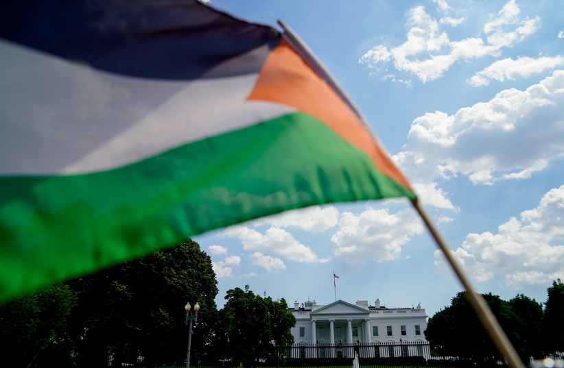 Activists wave a Palestinian flag outside the White House during a memorial for Palestinians who have died during the past year of Israeli-Palestinian violence, in Washington, US, June 5, 2021. (photo credit: REUTERS/ERIN SCOTT)