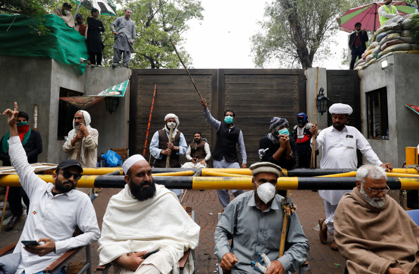  Supporters of former Pakistani prime minister Imran Khan gather, as they guard the entrance of Khan's house, in Lahore, Pakistan March 17, 2023.  (credit: Akhtar Soomro/Reuters)