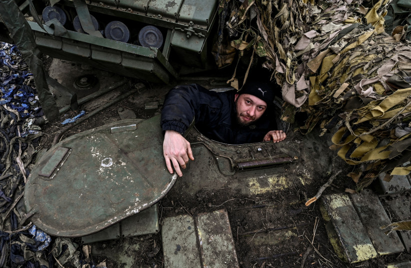  A Ukrainian serviceman looks out of a tank at a position near a frontline, amid Russia's attack on Ukraine, in Zaporizhzhia region, Ukraine March 16, 2023. (credit: STRINGER/ REUTERS)
