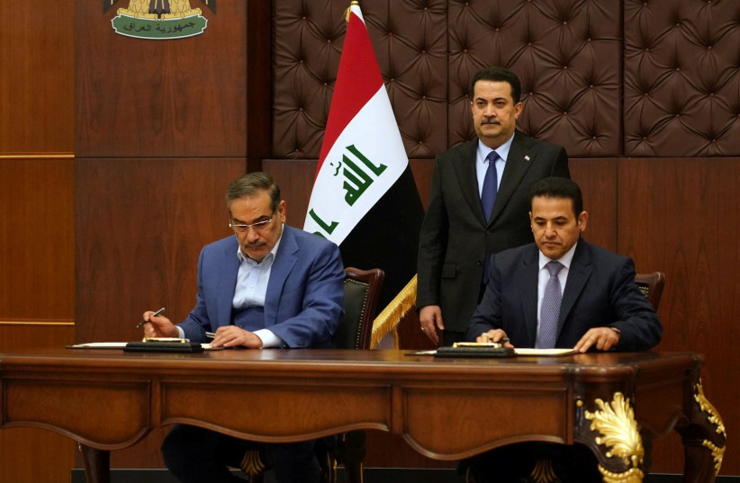 Iraqi Prime Minister Mohammed Shia al-Sudani looks on as Iraq's National Security Adviser Qasim al-Araji and Iran's Supreme National Security Council secretary Ali Shamkhani sign the security agreement that includes coordination in protecting the common borders between the two countries, in Baghdad (photo credit: IRAQI PRIME MINISTER MEDIA OFFICE/HANDOUT VIA REUTERS)