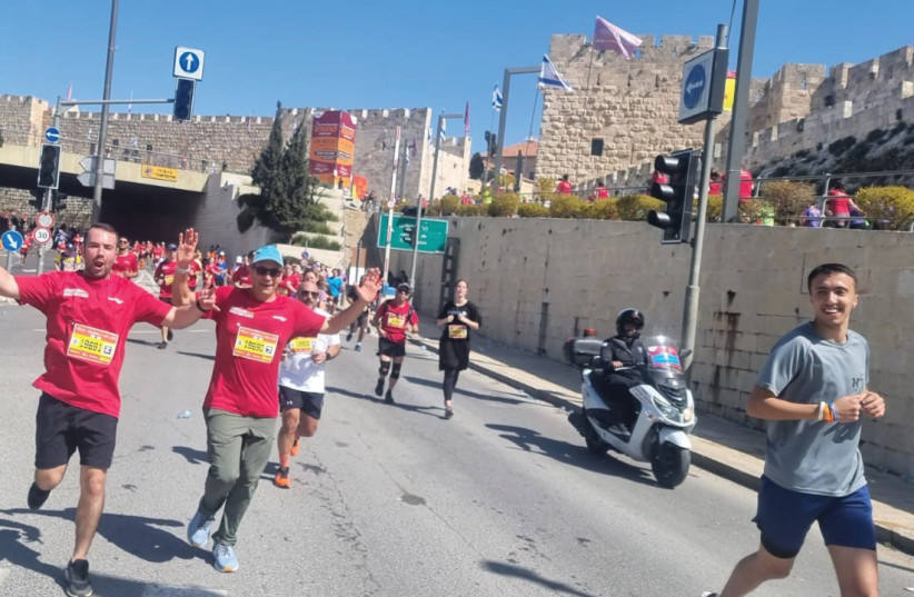  THE WRITER and son, Yoni, get set to run through the Old City in the Jerusalem Marathon, last Friday. (photo credit: NITAY NEFESH)