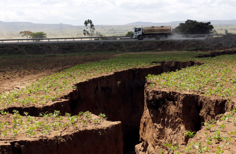 A tanker drives near a chasm suspected to have been caused by a heavy downpour along an underground fault-line near the Rift Valley town of Mai-Mahiu. (photo credit: REUTERS)