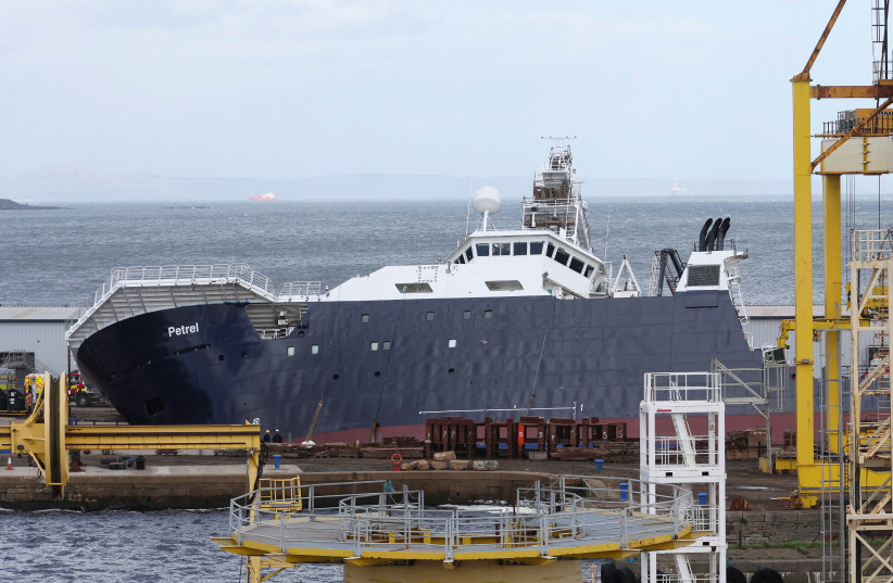 View of the research vessel Petrel after it tipped on its side in a dry dock in Leith, near Edinburgh, Scotland, Britain, March 22, 2023. (photo credit: REUTERS/RUSSELL CHEYNE)