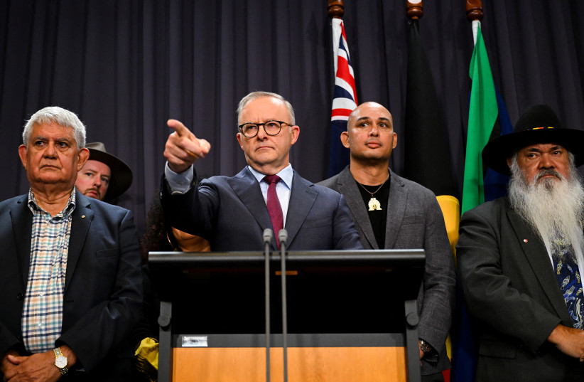  Australian Prime Minister Anthony Albanese, surrounded by members of the First Nations Referendum Working Group, speaks to the media during a news conference at Parliament House in Canberra, March 23, 2023. (photo credit: AAP Image/Lukas Coch via REUTERS)