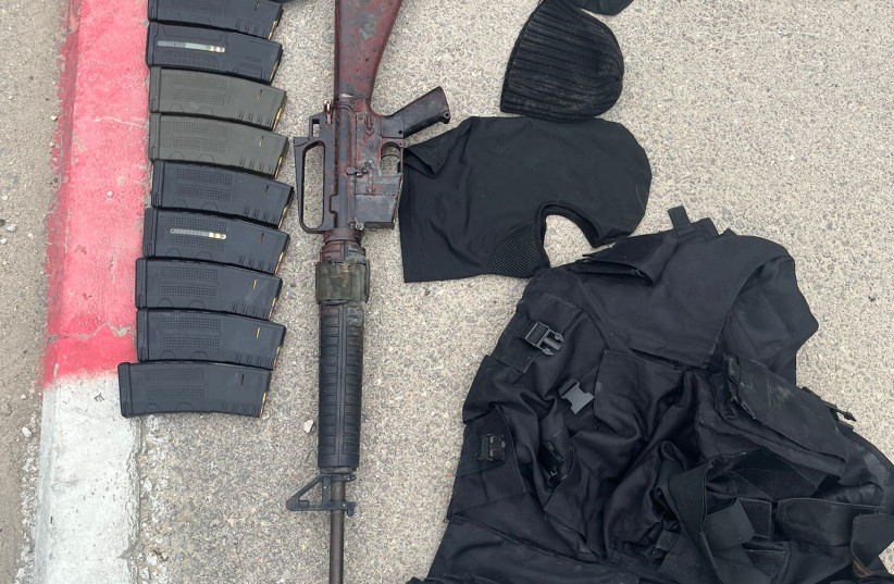  An M-16, a military vest, various other military items and the car which the terrorist had used to perpetrate his attacks, which were all confiscated by Israeli security forces, on March 23, 2023.. (photo credit: IDF SPOKESPERSON'S UNIT)