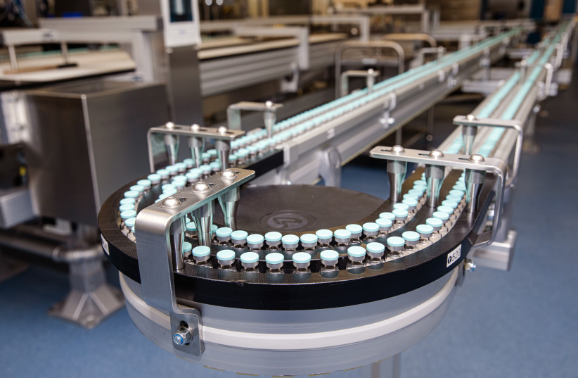  VACCINE VIALS travel along the conveyor belt at the Pfizer Purrs manufacturing and packing site. (credit: Pfizer with permission)