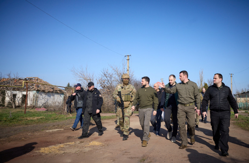  Ukraine's President Volodymyr Zelenskiy walks along a street in a village, amid Russia's attack on Ukraine, as he visits Kherson region, Ukraine March 23, 2023.  (credit: UKRAINIAN PRESIDENTIAL PRESS SERVICE/REUTERS)
