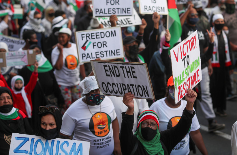  South African demonstrators carry placards during a protest following clashes between Palestinians and Israeli police at Al Asqa Mosque in Jerusalem, in Cape Town, South Africa, May 12, 2021 (photo credit: REUTERS/MIKE HUTCHINGS)