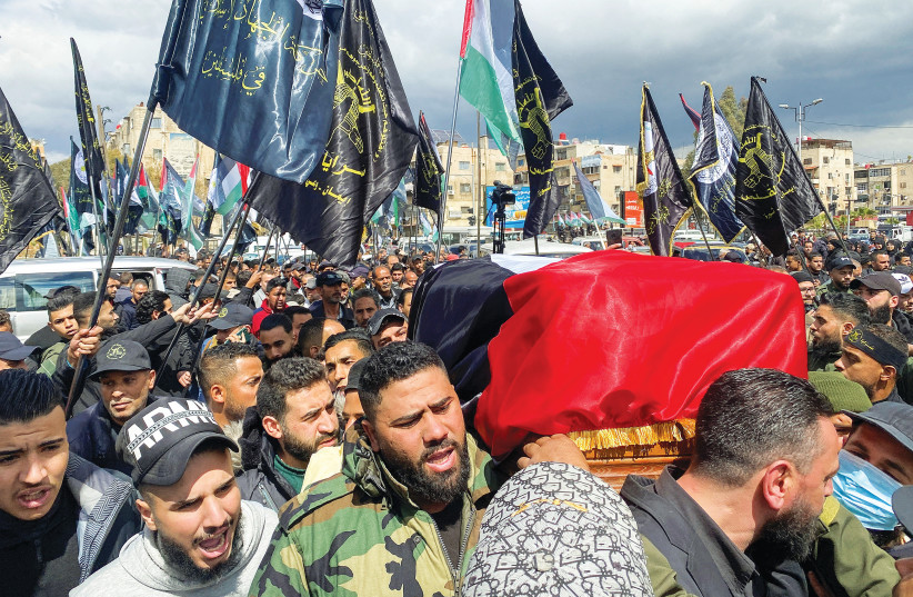  The Coffin of Ali Ramzi al-Aswad, a senior member of the Palestinian Islamic Jihad, is carried in a funeral parade in Damascus on March 20. (photo credit: FIRAS MAKDESI/REUTERS)