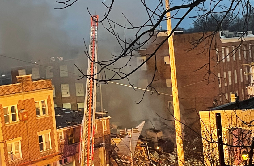A general view shows smoke coming out from a chocolate factory after fire broke out, in West Reading, Pennsylvania, U.S., March 24, 2023 in this picture obtained from social media. (photo credit: Twitter @Based_In410/via REUTERS)