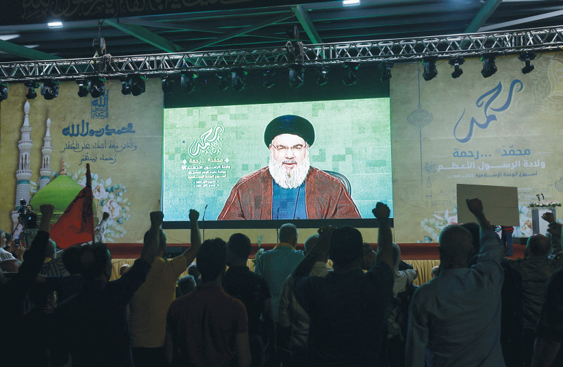  HEZBOLLAH LEADER Hassan Nasrallah delivers a video address to supporters. Hezbollah media have been mobilized to portray the protests as reflecting the imminent end of the Zionist entity.  (photo credit: AZIZ TAHER/REUTERS)