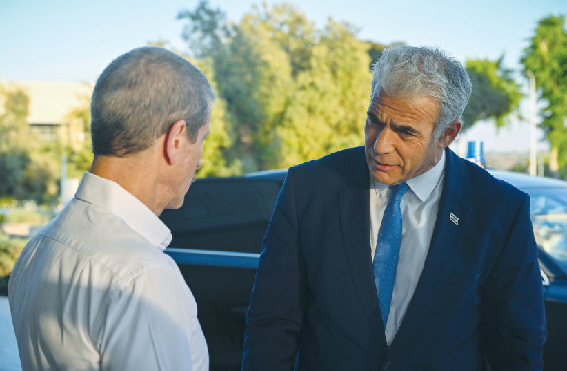  OUTGOING ISRAEL Atomic Energy Commission head Ze’ev Snir speaks with then-prime minister Yair Lapid, as Snir left the position, on July 31. (photo credit: KOBI GIDEON/GPO)
