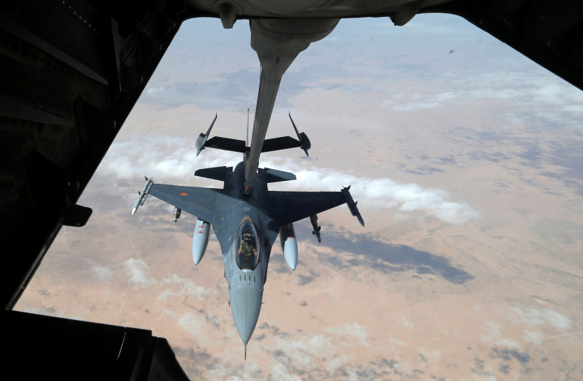 A US Air Force F-16 receives fuel from a fuel boom suspended from a US Air Force KC-10 Extender during mid-air refueling support to Operation Inherent Resolve over Iraqi and Syrian airspace, March 15, 2017. (photo credit: REUTERS/HAMAD I MOHAMMED)