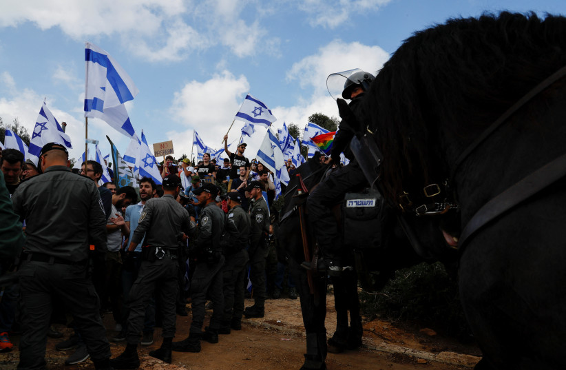 Mounted police officers confront judicial reform demonstrators in Jerusalem, March 27, 2023 (photo credit: AMMAR AWAD/REUTERS)