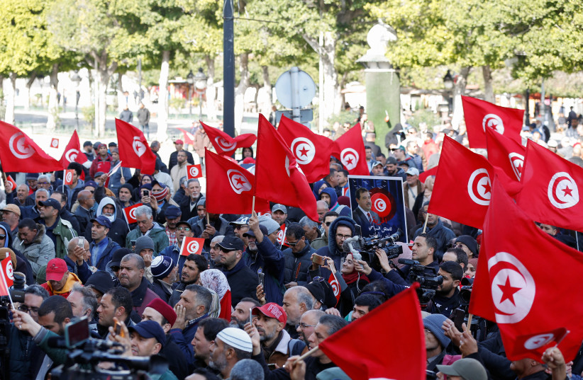  Supporters of Tunisia's Salvation Front opposition wave flags during a protest over the arrest of some of its leaders and other prominent critics of the president, in Tunis, Tunisia March 5, 2023. (credit: REUTERS/ZOUBEIR SOUISSI)