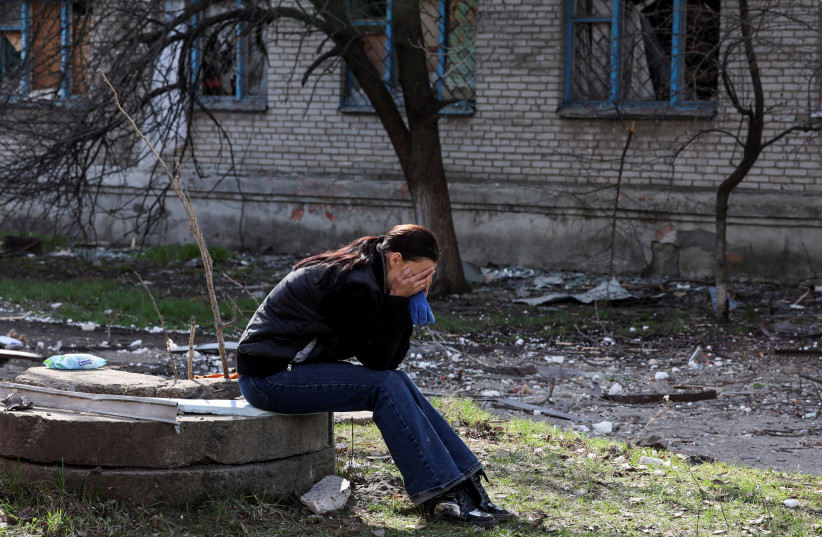  A woman reacts in the aftermath of deadly shelling of an army office building, amid Russia's attack, in Sloviansk, Ukraine, March 27, 2023.  (photo credit: REUTERS/VIOLETA SANTOS MOURA)