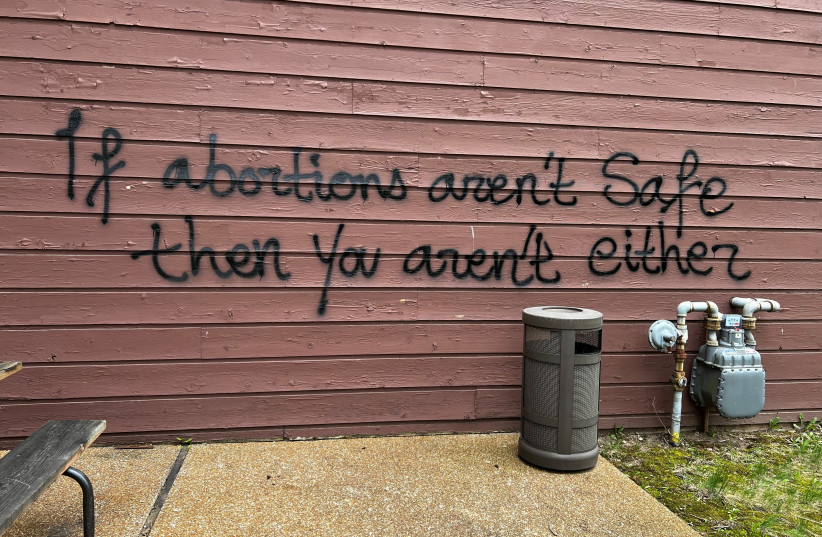 A threat is spray painted on the building wall near Wisconsin Family Action's offices in Madison, Wisconsin, U.S. May 8, 2022 (photo credit: REUTERS)