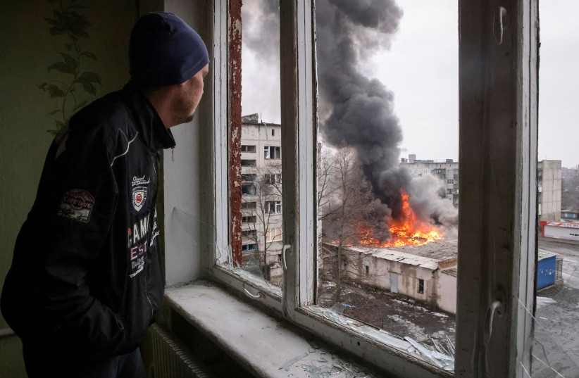  A local resident looks at a buildings damaged by a Russian military strike, amid Russia's attack on Ukraine, in the city of Chasiv Yar, in Donetsk region, Ukraine February 27, 2023. (photo credit: REUTERS)