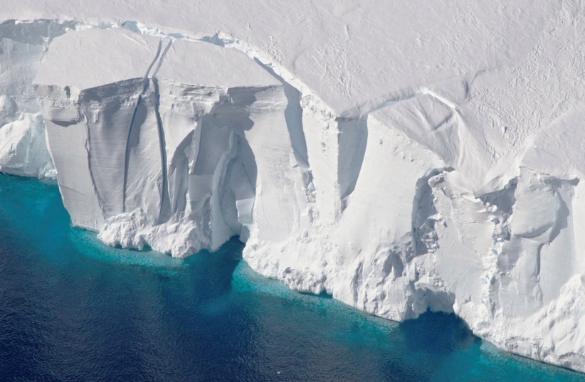  An aerial view of the 200-foot-tall (60-meter-tall) front of the Getz Ice Shelf with cracks, in Antarctica, in this 2016 handout image. (photo credit: NASA TV/Handout via REUTERS)