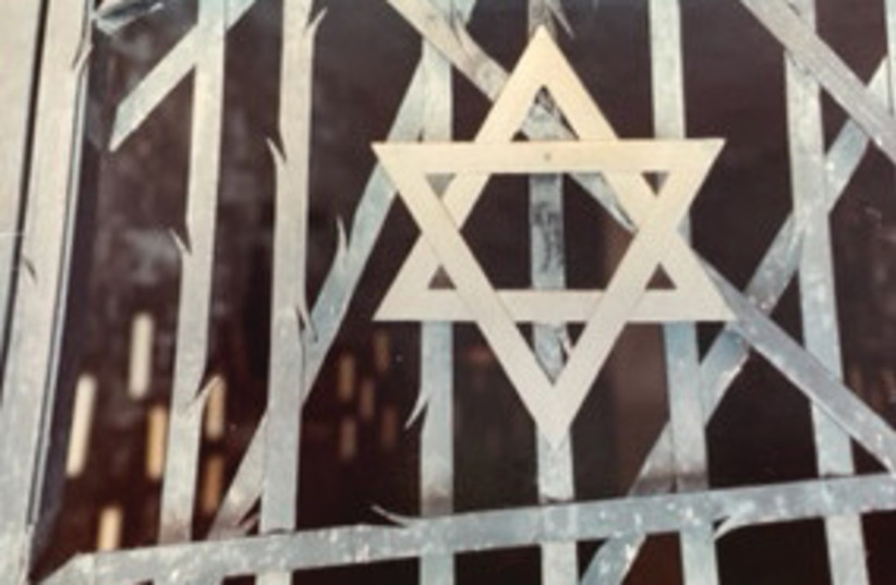  A STAR OF DAVID placed at the center of the gate of a memorial that the survivors of Bavarian Jewry established in the Dachau concentration camp, just a few miles from Munich.  (credit: ELI KAVON)