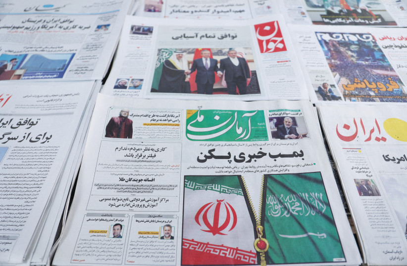  A TEHRAN newspaper sports a cover photo of the Iranian and Saudi Arabian flags.  (photo credit: Majid Asgaripour/WANA via Reuters)