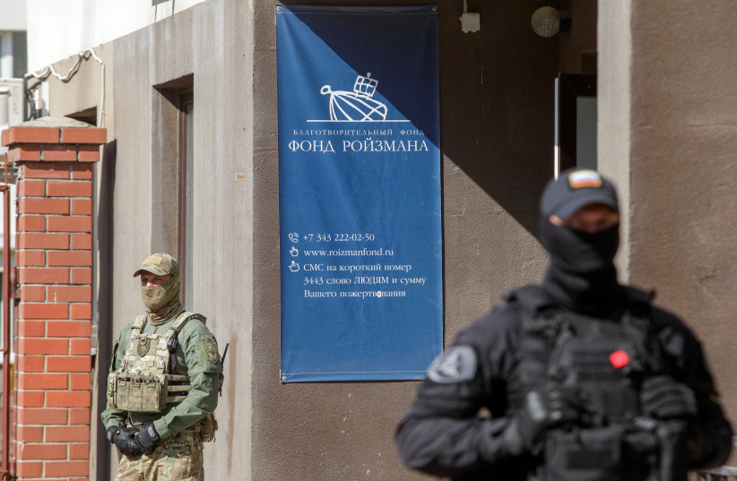  Russian law enforcement officers stand guard outside the office of Roizman Charity Fund, after its founder and politician Yevgeny Roizman was reportedly detained in Yekaterinburg, Russia August 24, 2022. (photo credit: REUTERS/STRINGER)