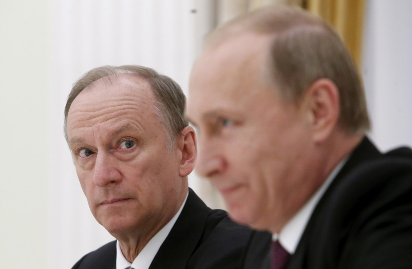  Russian Security Council Secretary Nikolai Patrushev (L) looks at President Vladimir Putin during a meeting with the BRICS countries' senior officials in charge of security matters at the Kremlin in Moscow, Russia, May 26, 2015. (photo credit: SERGEI KARPUKHIN/REUTERS)