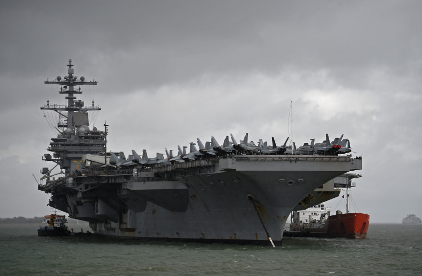  The USS George H.W. Bush aircraft carrier is seen anchored off Stokes Bay in the Solent, Britain, July 27, 2017. (photo credit: REUTERS/HANNAH MCKAY/FILE PHOTO)
