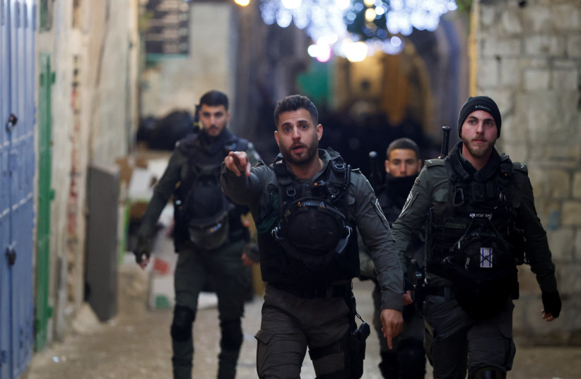  Israeli police walk near a security incident scene near the compound known to Muslims as Al-Aqsa or the Noble Sanctuary and to Jews as the Temple Mount, in Jerusalem's Old City, April 1, 2023.  (photo credit: REUTERS/AMMAR AWAD)