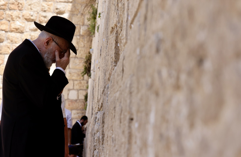  A man prays at the Western Wall in the Old City of Jerusalem.  (credit: MARC ISRAEL SELLEM)