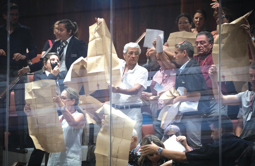  PROTESTERS IN the visitors’ gallery hold up copies of the Declaration of Independence, as the Knesset plenum discusses the passage of Basic Law: Israel – the Nation State of the Jewish People, in 2018. (photo credit: YONATAN SINDEL/FLASH90)