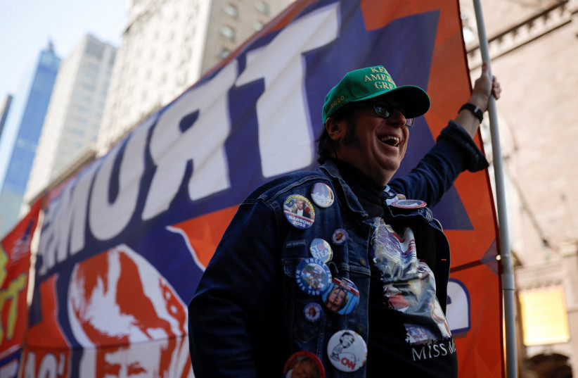  Pro-Trump protester holds a flag after former US President Donald Trump's indictment by a Manhattan grand jury following a probe into hush money paid to porn star Stormy Daniels, in New York City, US, April 3, 2023.   (photo credit: REUTERS/AMANDA PEROBELLI)