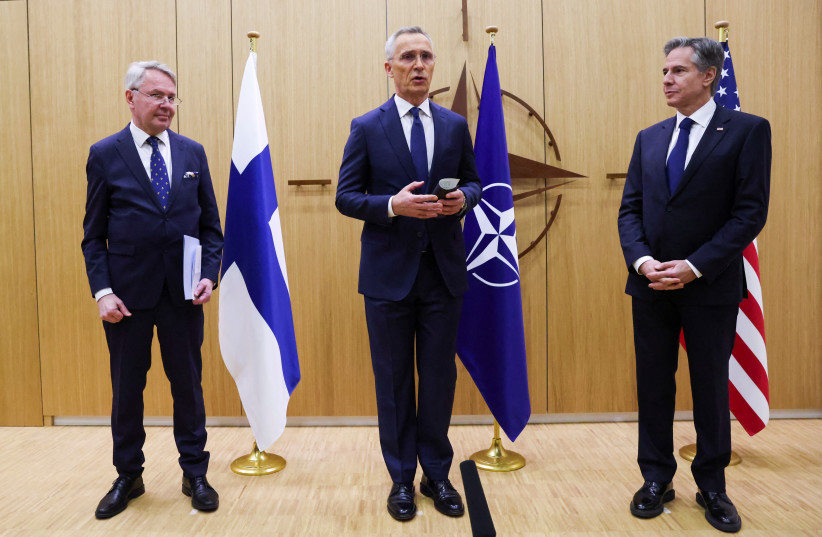  NATO Secretary-General Jens Stoltenberg speaks as Finnish Foreign Minister Pekka Haavisto hands his nation's accession document to US Secretary of State Antony Blinken during a joining ceremony at the NATO foreign ministers' meeting at the Alliance's headquarters in Brussels, Belgium April 4, 2023. (photo credit: Johanna Geron/Pool/Reuters)