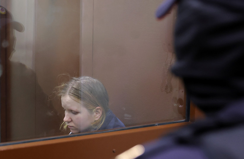 Darya Trepova, who is suspected of the killing of Russian military blogger Maxim Fomin widely known by the name of Vladlen Tatarsky, sits behind a glass wall of an enclosure for defendants before a court hearing in Moscow, Russia, April 4, 2023.  (photo credit: EVGENIA NOVOZHENINA/REUTERS)