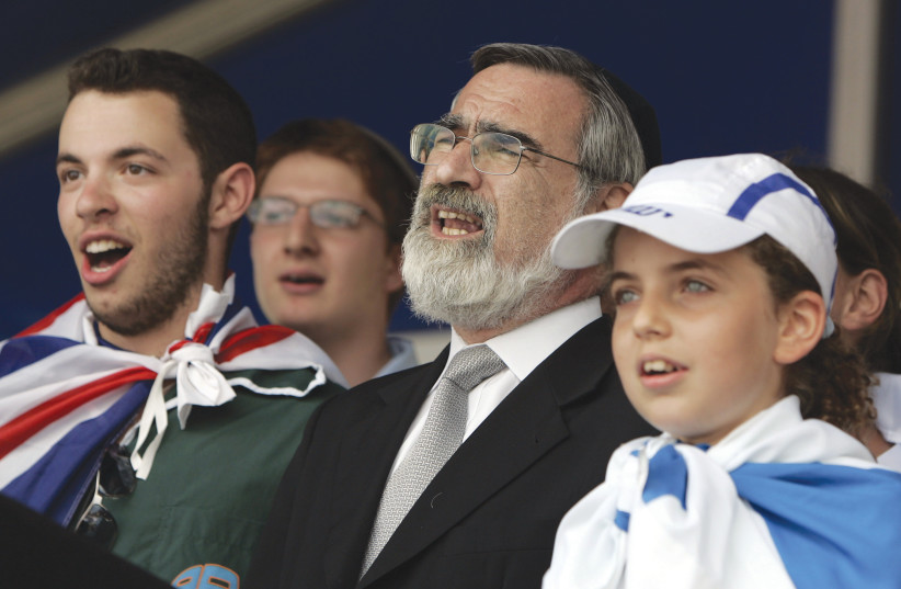  THEN-CHIEF RABBI of the United Hebrew Congregations of the Commonwealth Lord Jonathan Sacks sings a prayer at a rally held in solidarity with Israel, in London, in 2006.  (credit: REUTERS)