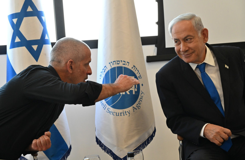 Shin Bet head Ronen Bar speaks with Prime Minister Benjamin Netanyahu at an awards ceremony on April 4, 2023.  (photo credit: KOBI GIDEON/GPO)