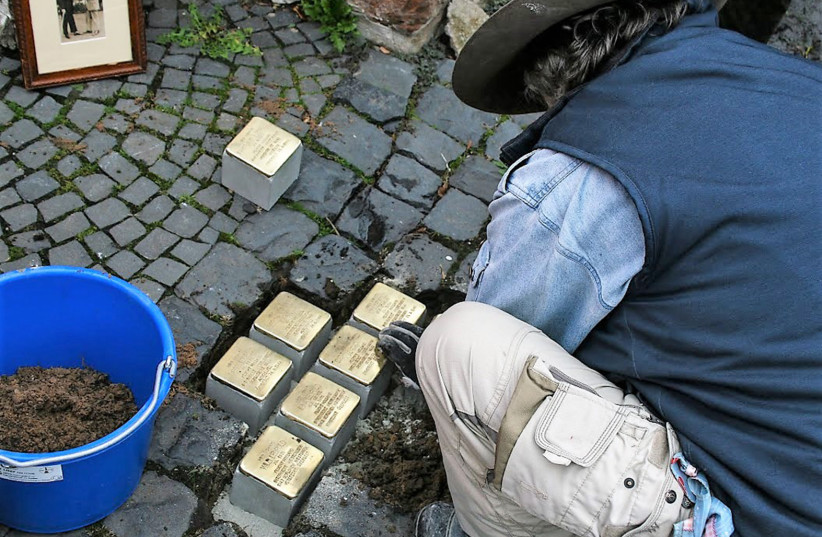  ARTIST GUNTER DEMNIG installs the Stumbling Stones. (photo credit: SHERYL ABBEY)